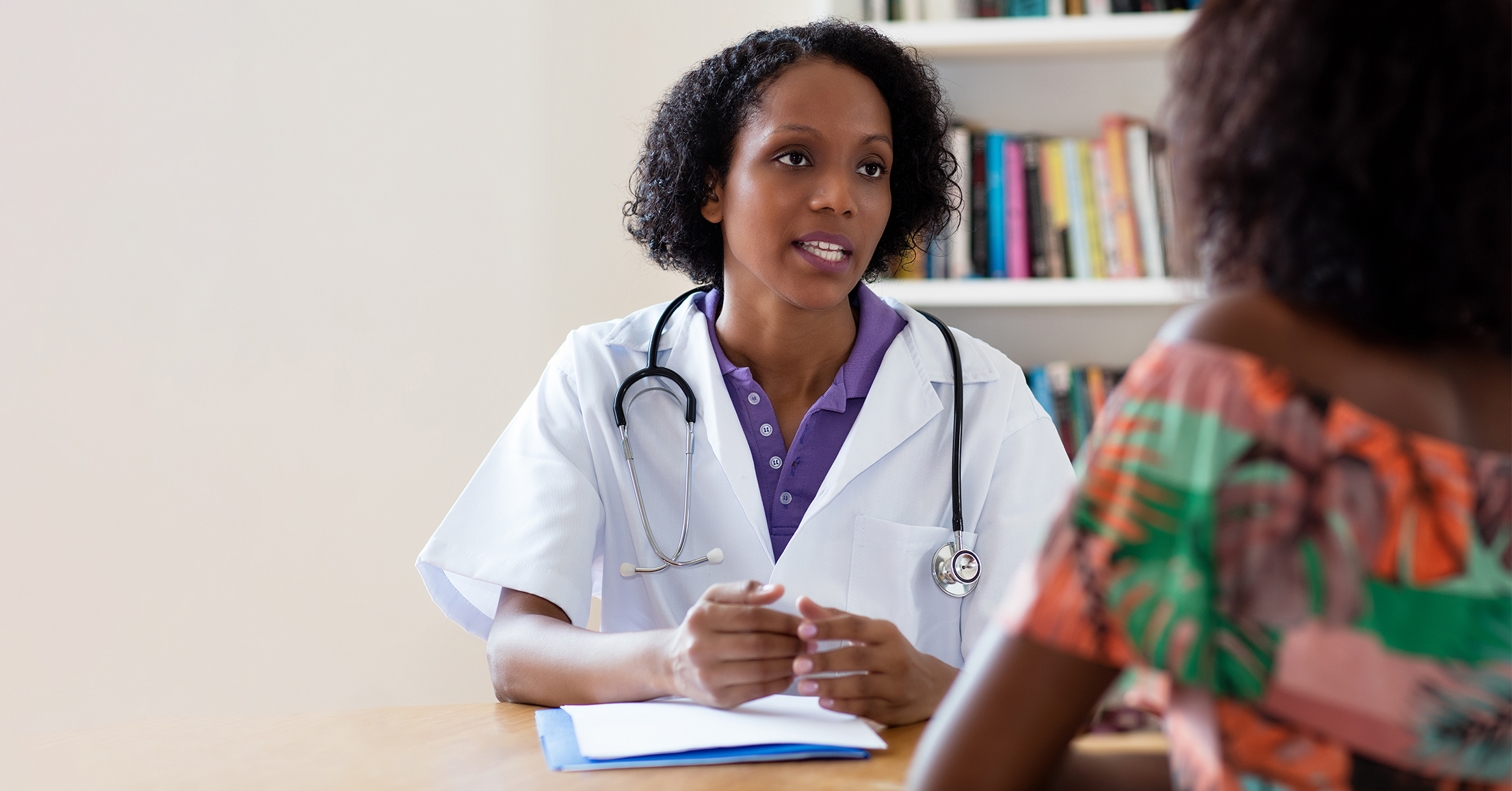 Female doctor consults a young woman